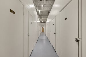 a row of white lockers in a prison hallway